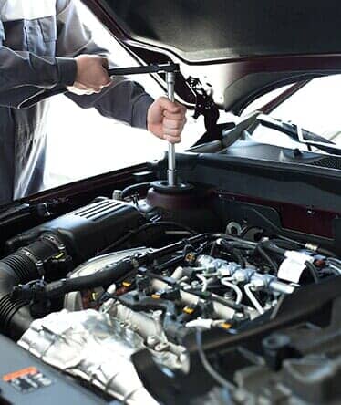 Man Repairing a Car — Engine Parts Merrillville, IN Man Repairing a Car — Engine Parts Merrillville, IN