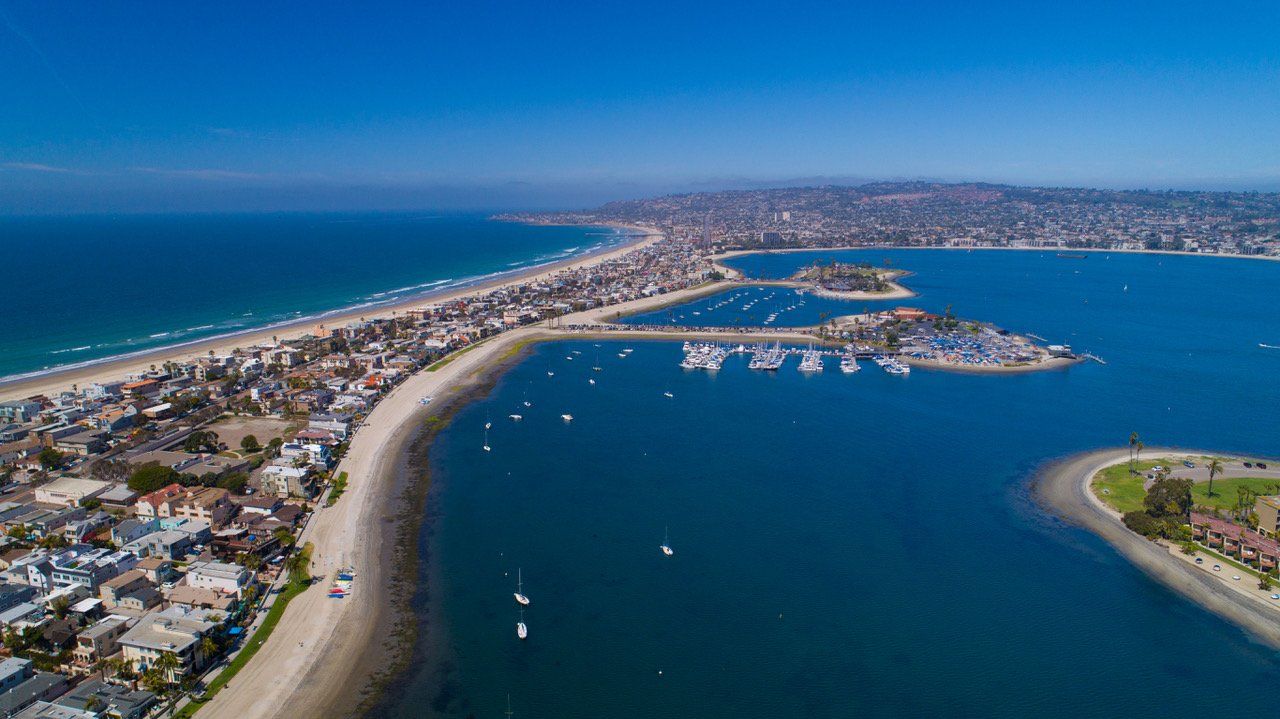 an aerial view of a large body of water surrounded by a city .