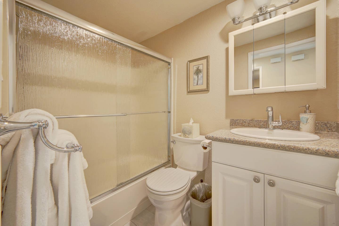 A bathroom with a toilet , sink , and shower.