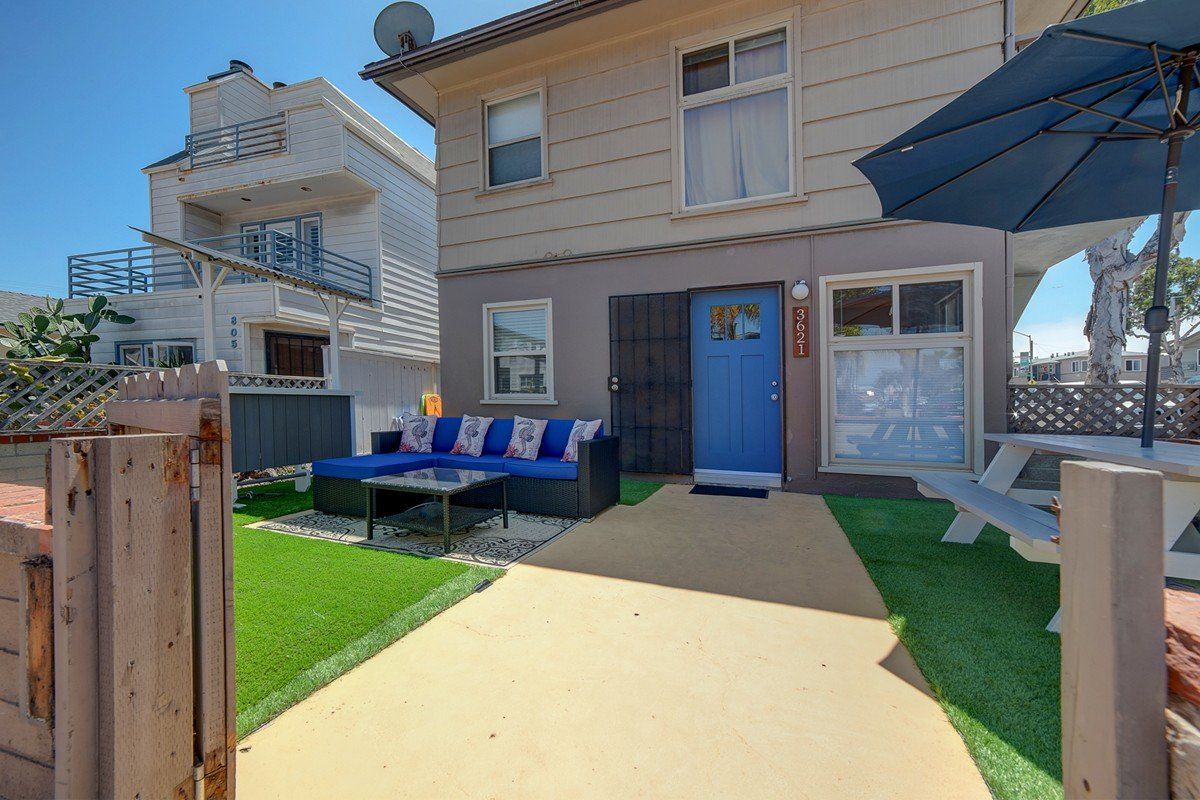 a house with a blue door and a couch in front of it .