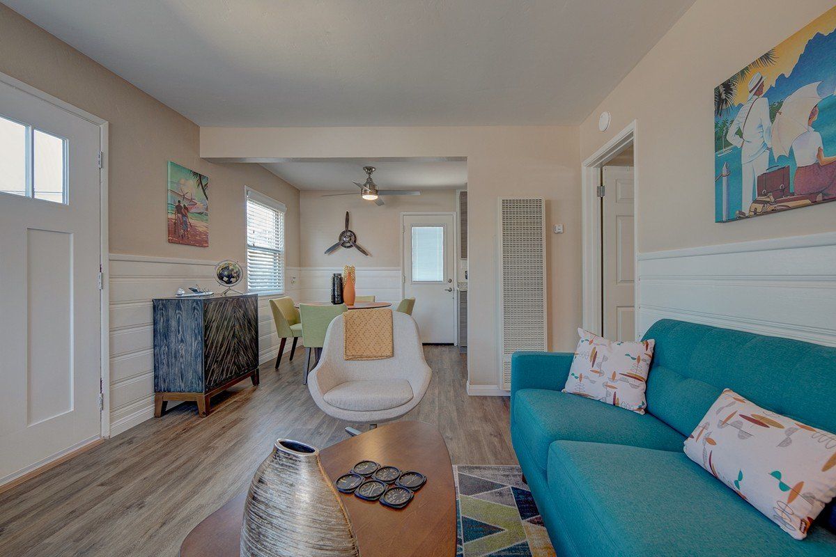 a living room with a blue couch and a coffee table .