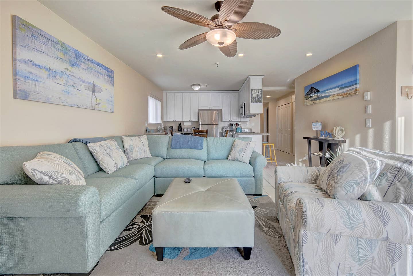 A living room filled with furniture and a ceiling fan.