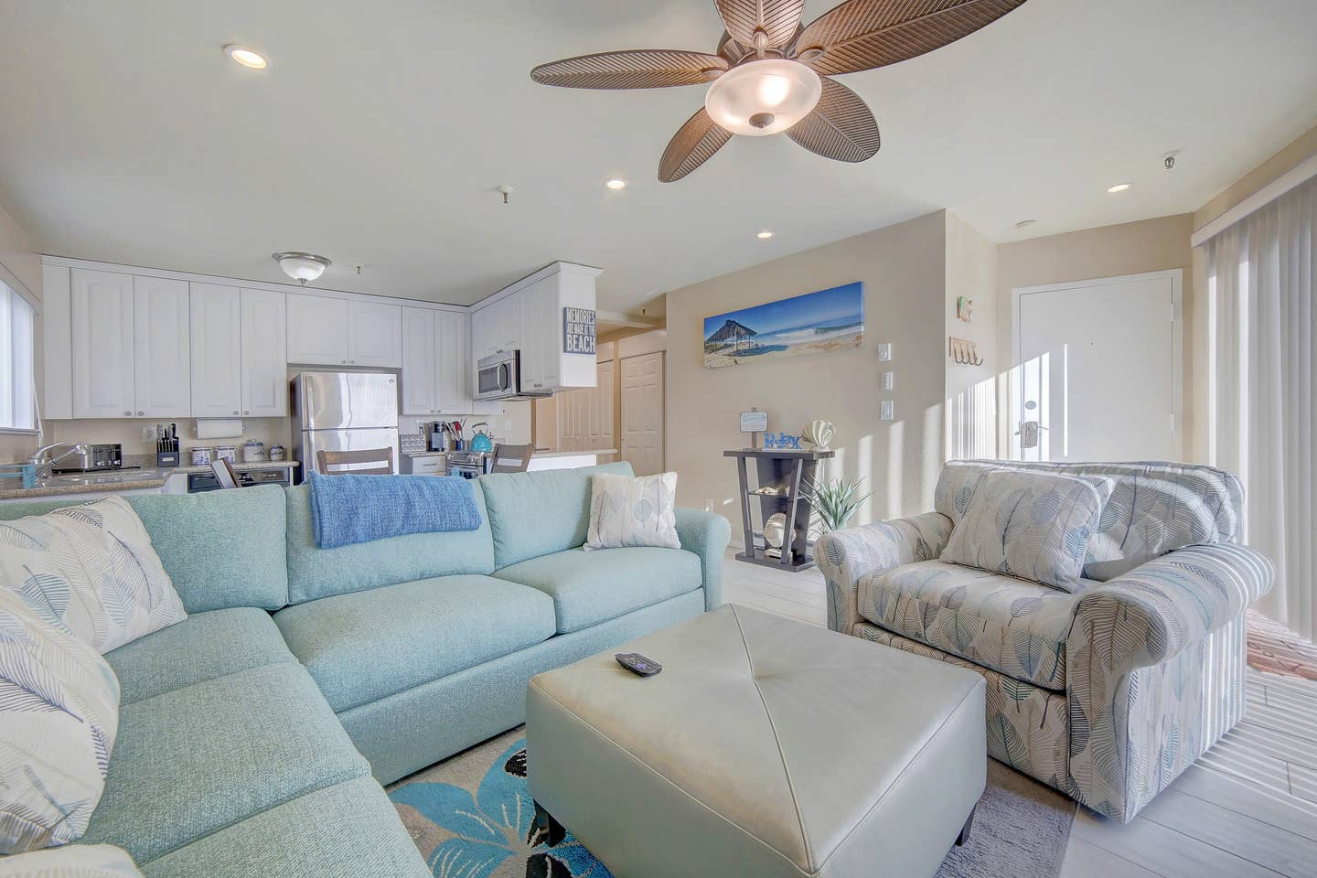 A living room filled with furniture and a ceiling fan.