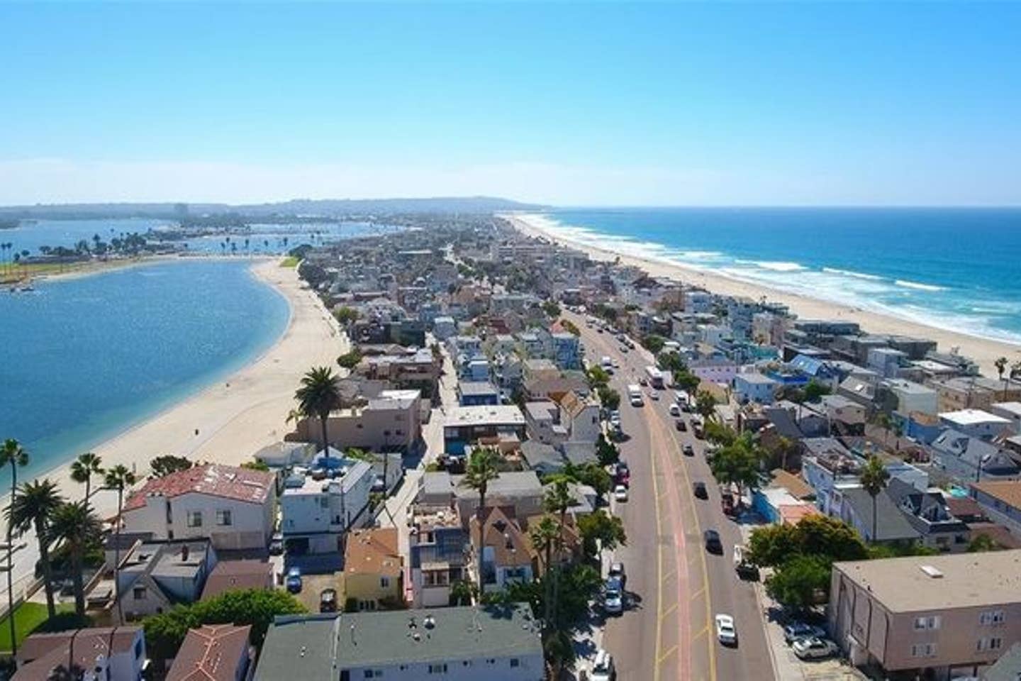 An aerial view of a city with a beach in the background