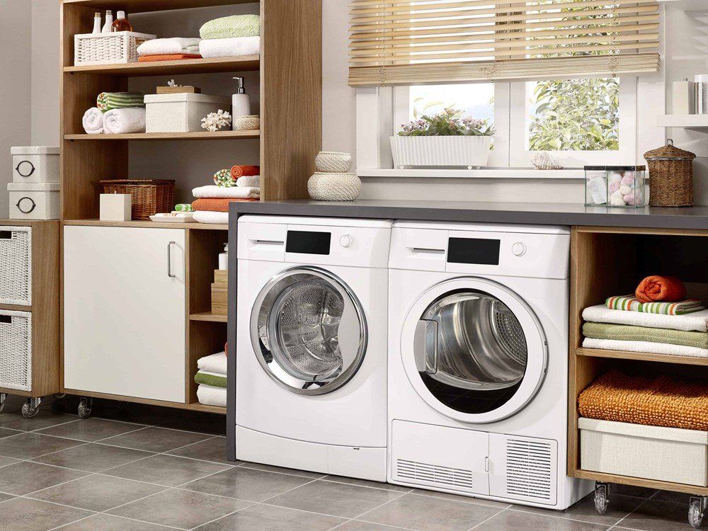 a laundry room with a washer and dryer and a window .