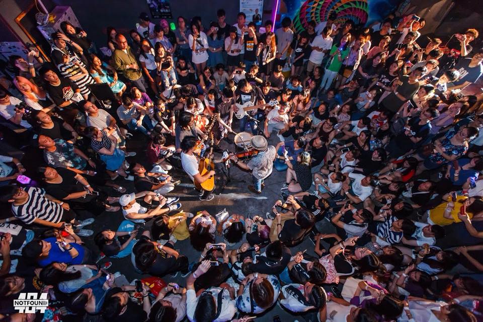 A large crowd of people are gathered at a concert.