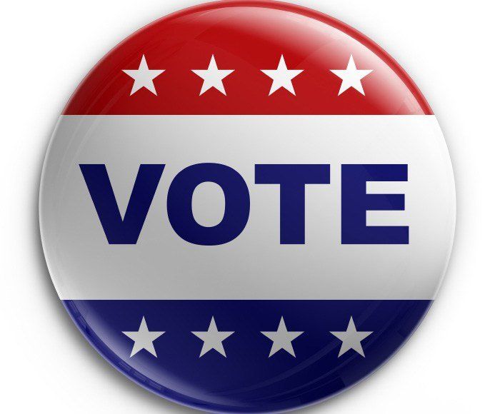A red white and blue button that says vote