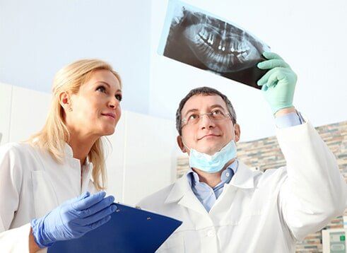 Dentist Studying the teeth - Cosmetic Dentistry in Farmingdale, NY Dentist Studying the teeth - Cosmetic Dentistry in Farmingdale, NY