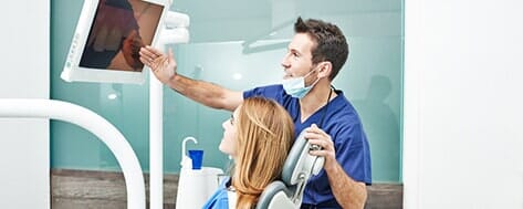 Dentist Instructing a Patient - Teeth whitening in Farmingdale, NY Dentist Instructing a Patient - Teeth whitening in Farmingdale, NY