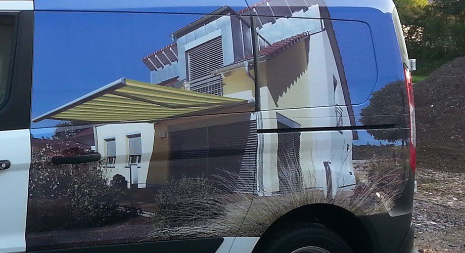 A van with a picture of a house on the side
