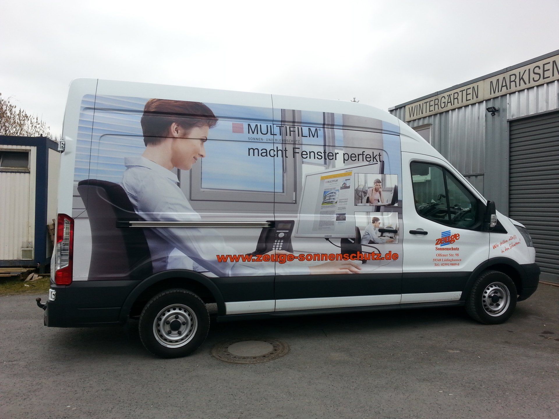 A white van with a picture of a man on the side