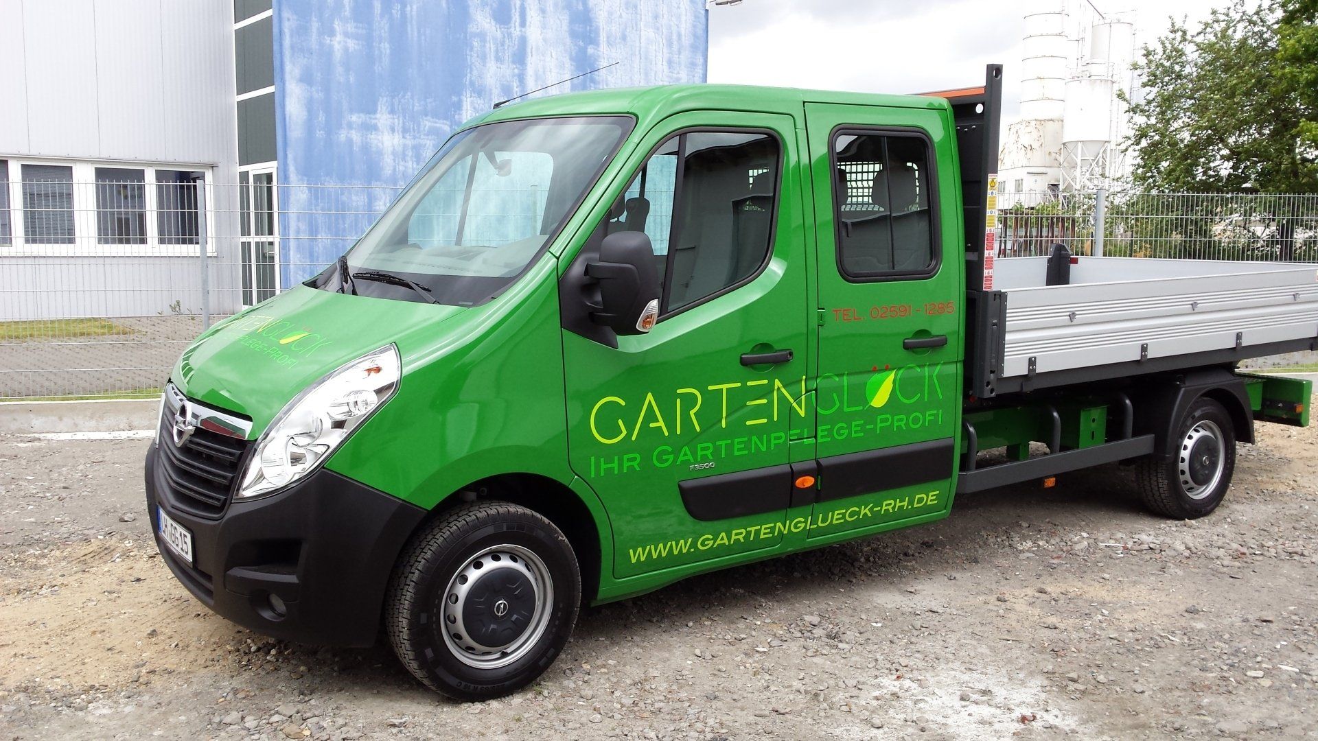 A green van with the word garten on the side is parked in front of a building.