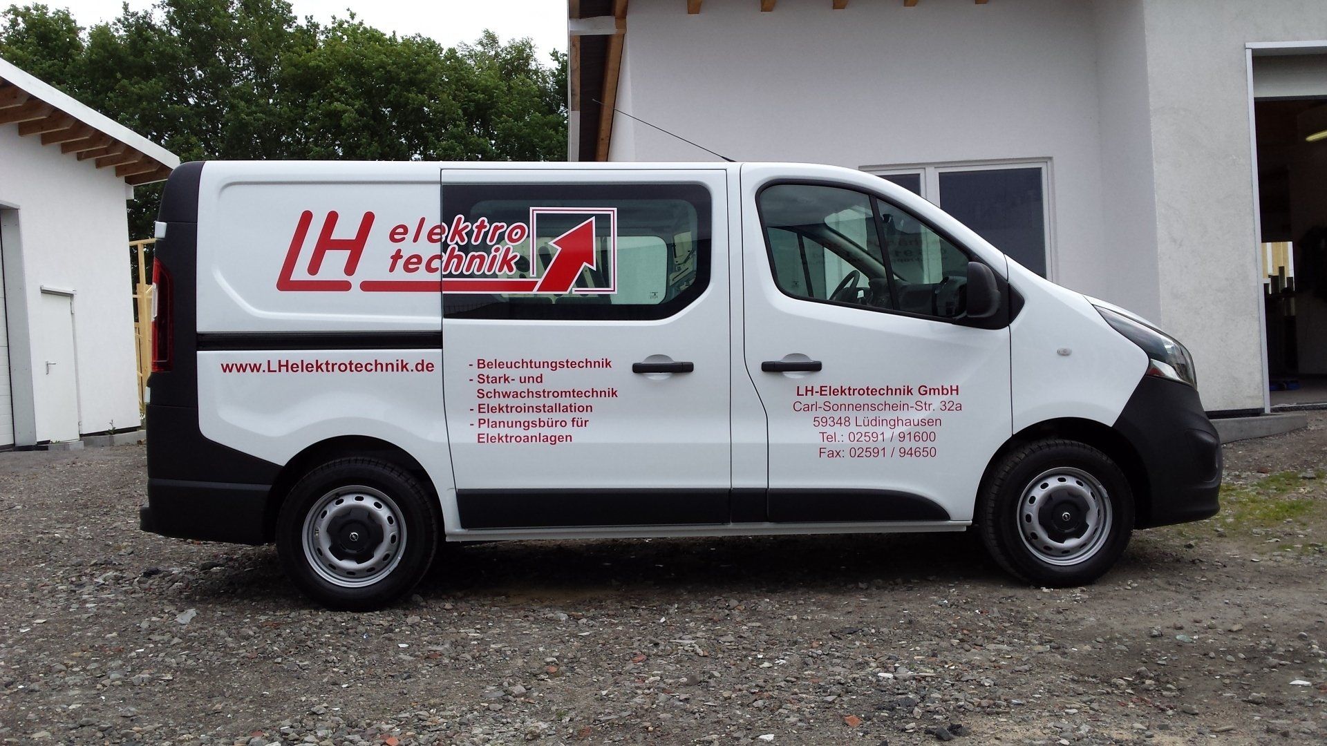 A white van with the word lh on the side
