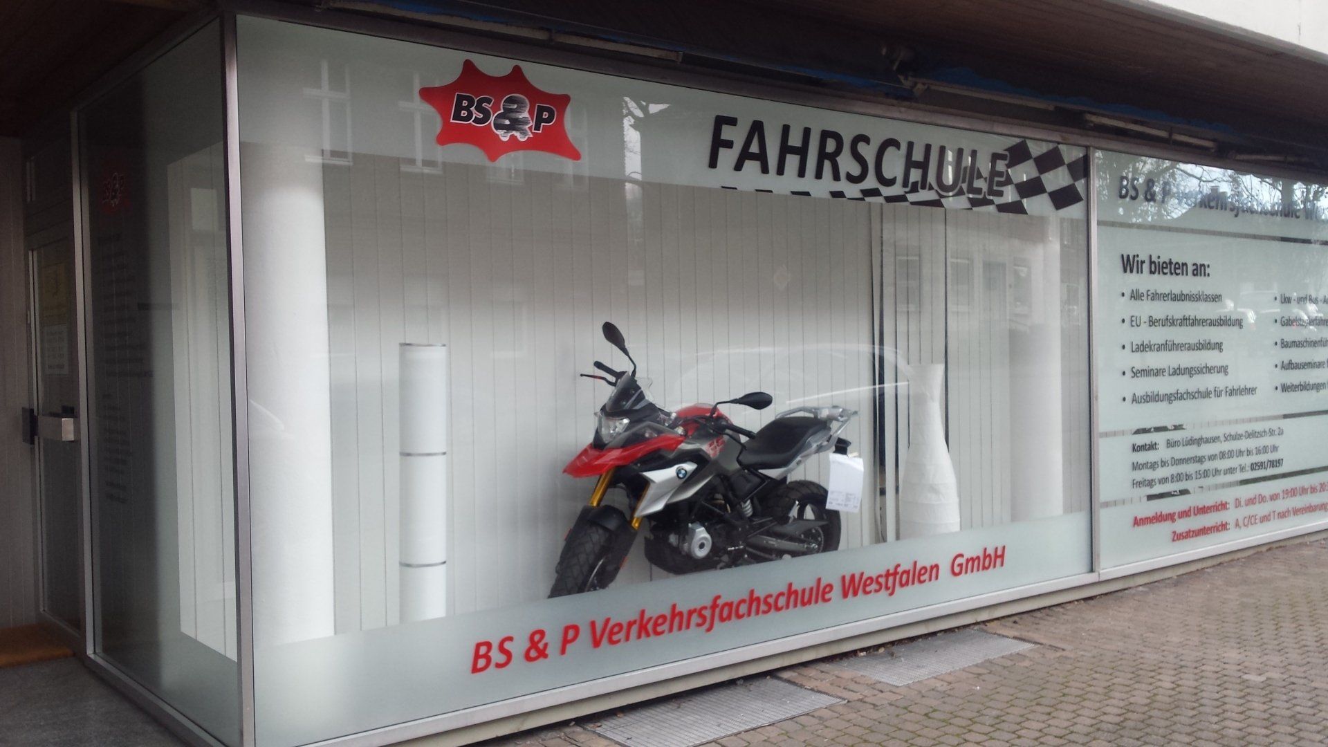 A motorcycle is displayed in a store window.