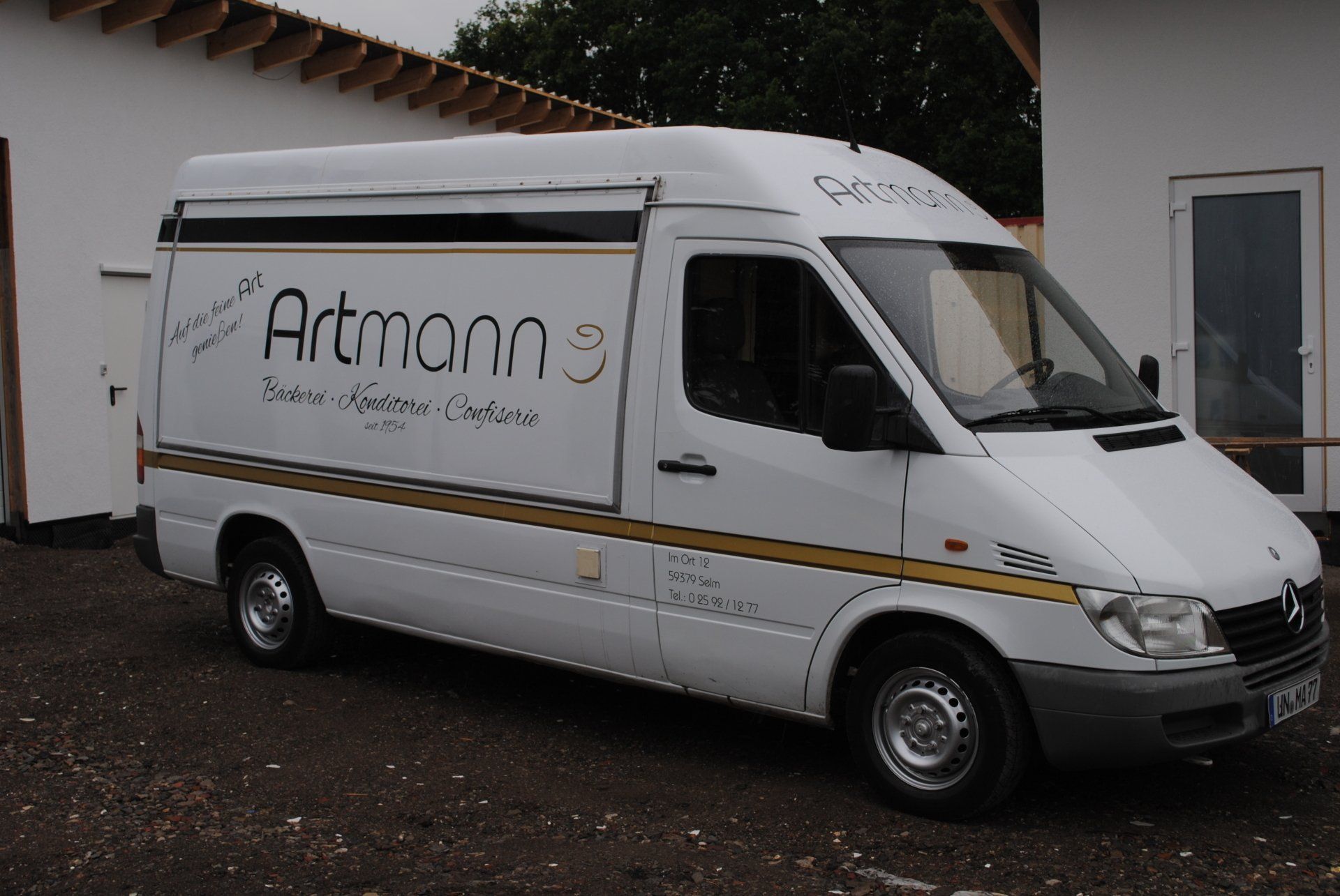 A white van with the word artmann on the side