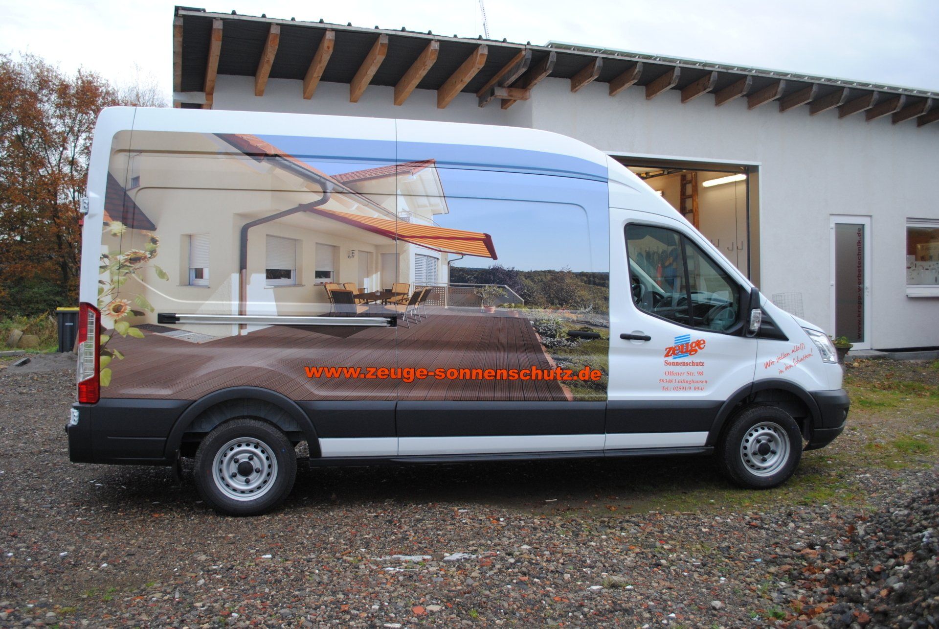A white van with a picture of a house on the side