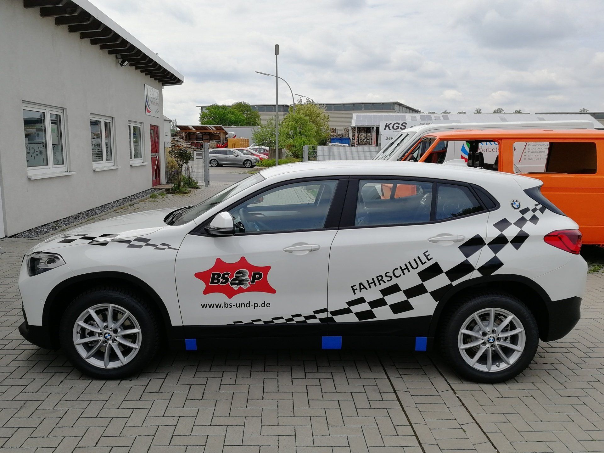 A white car with the word mar on the side