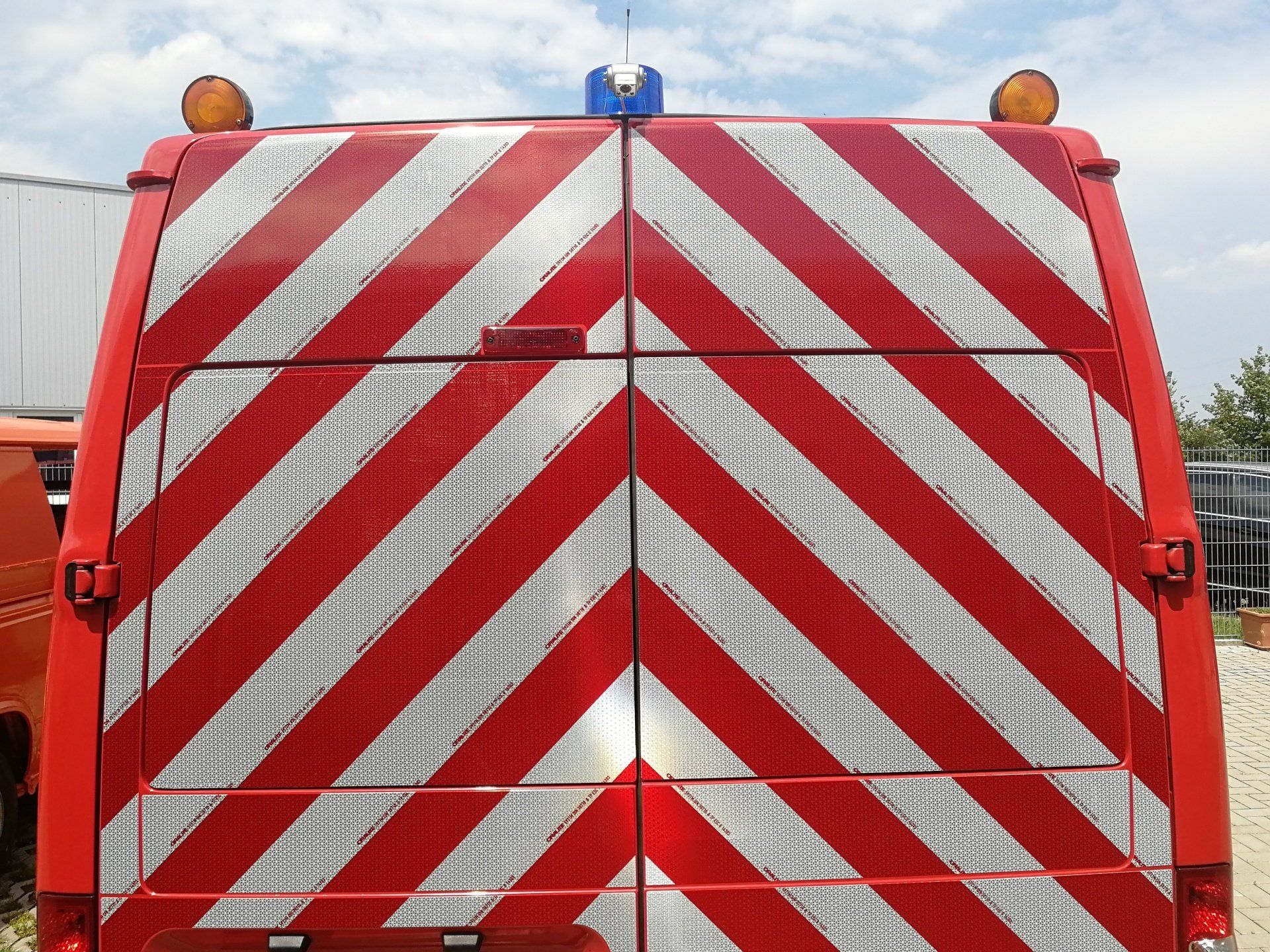 The back of a red and white striped van