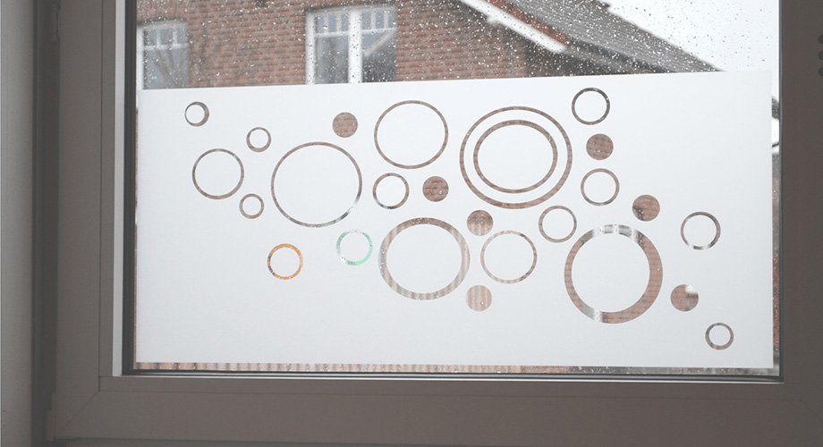 A window with a sticker on it that looks like bubbles.