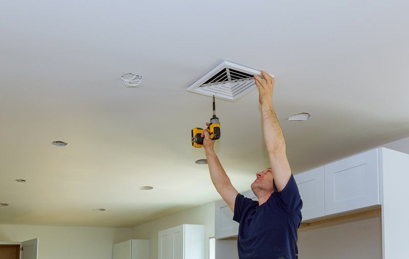 Man Installing Duct On Room — Cairo, GA — Parker’s Heating & Cooling, Inc.
