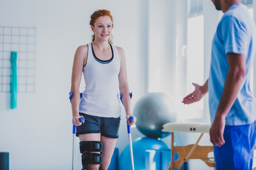 Balance Training — Woman Walking with Crutches in Naples, FL Balance Training — Woman Walking with Crutches in Naples, FL