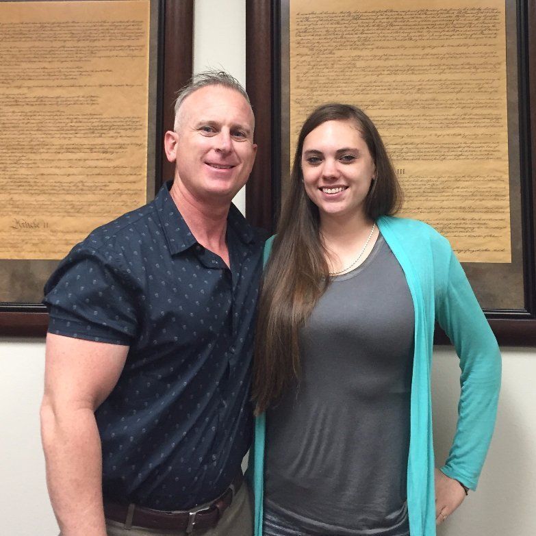 A man and a woman are posing for a picture