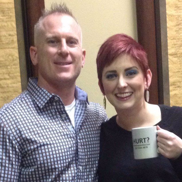 A woman is holding a mug that says hurt on it