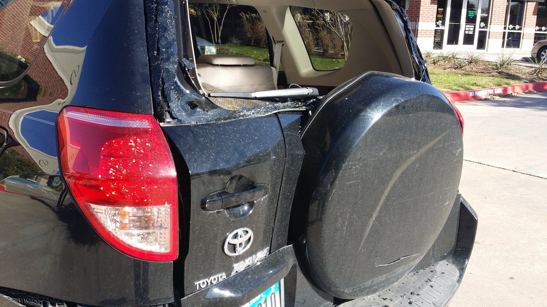 A black toyota rav4 with a broken windshield