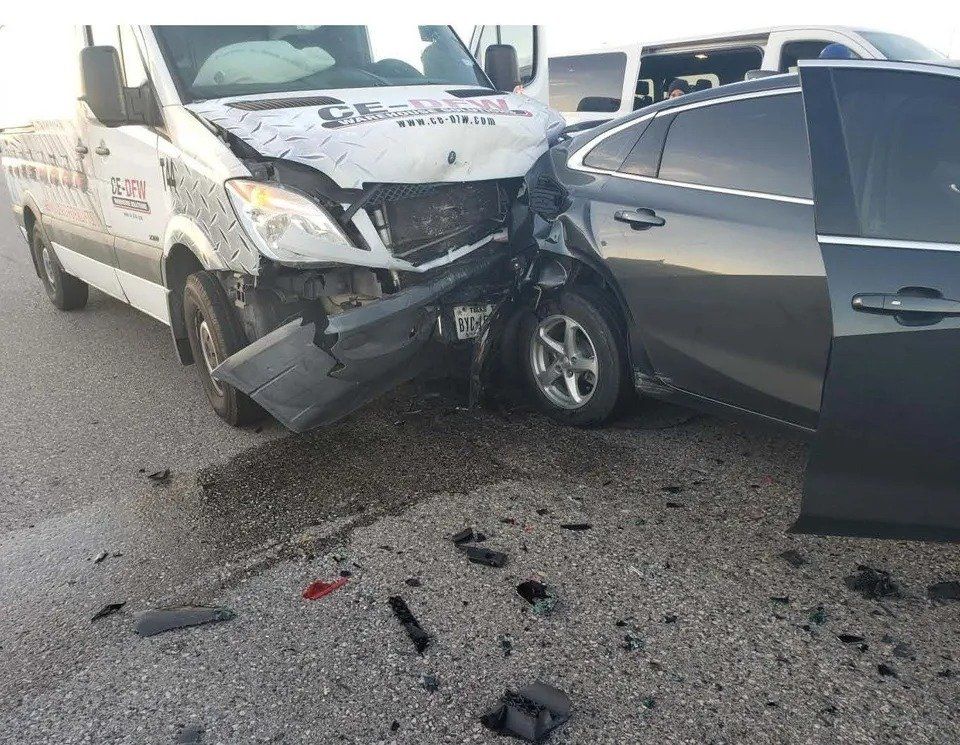 A white van and a black car are involved in a car accident.