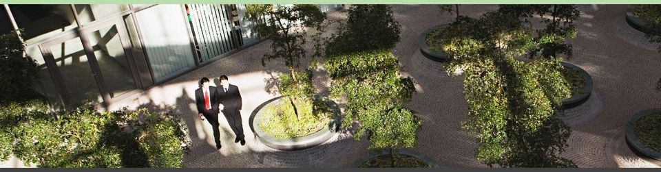 two office workers in courtyard with exterior plants