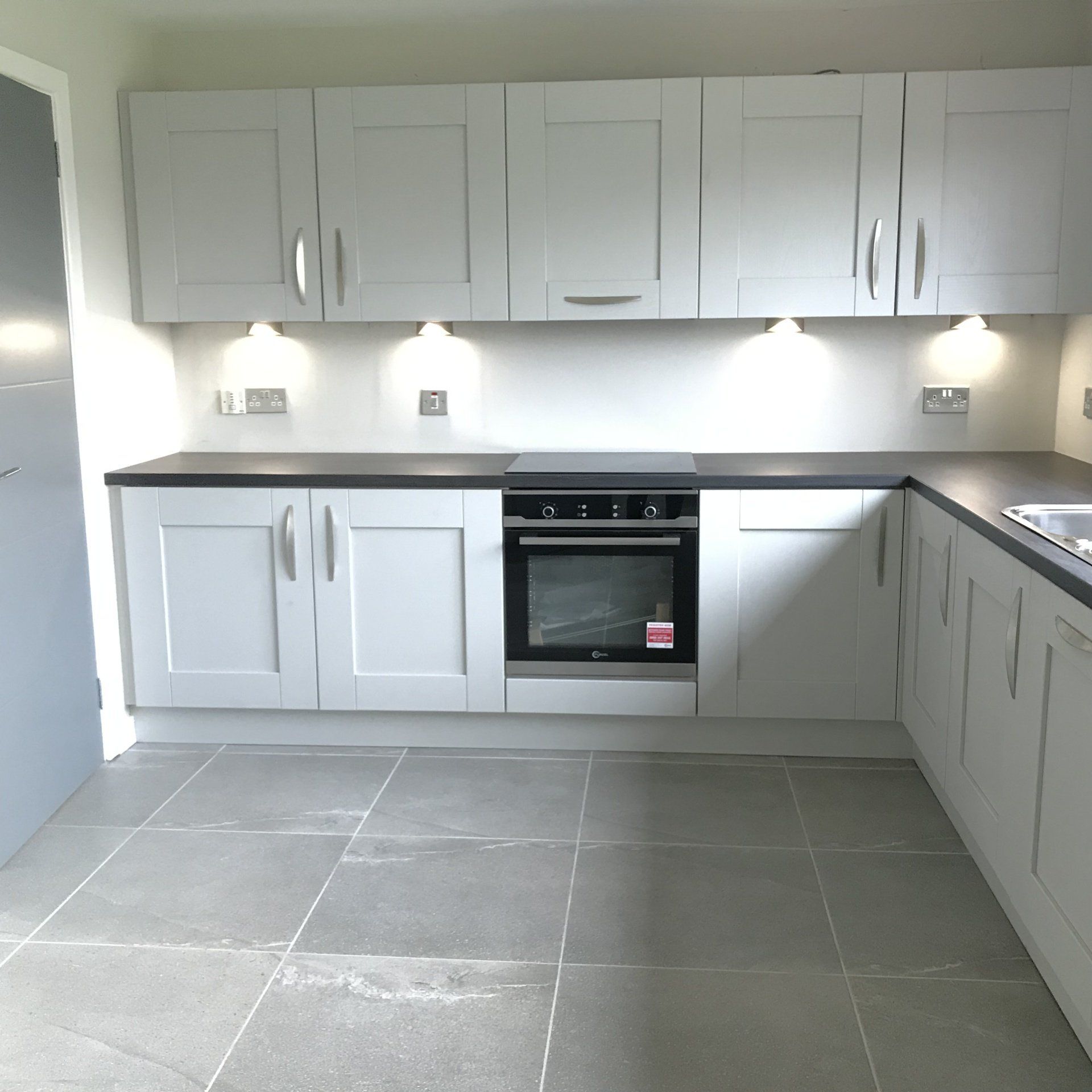 A kitchen with white cabinets and a lg oven