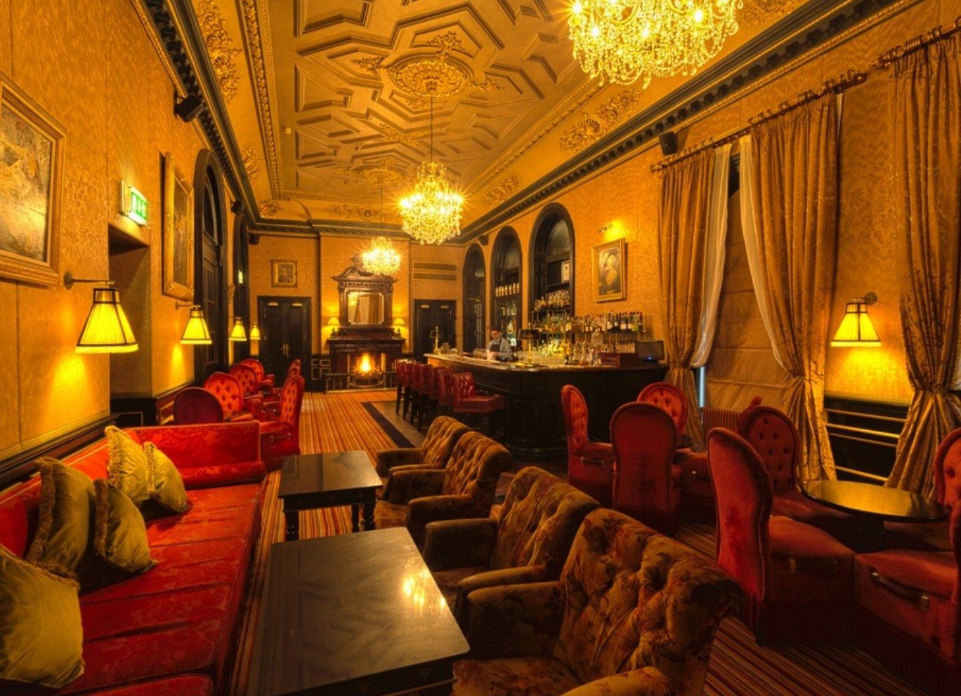 A large room with lots of furniture and a bar.