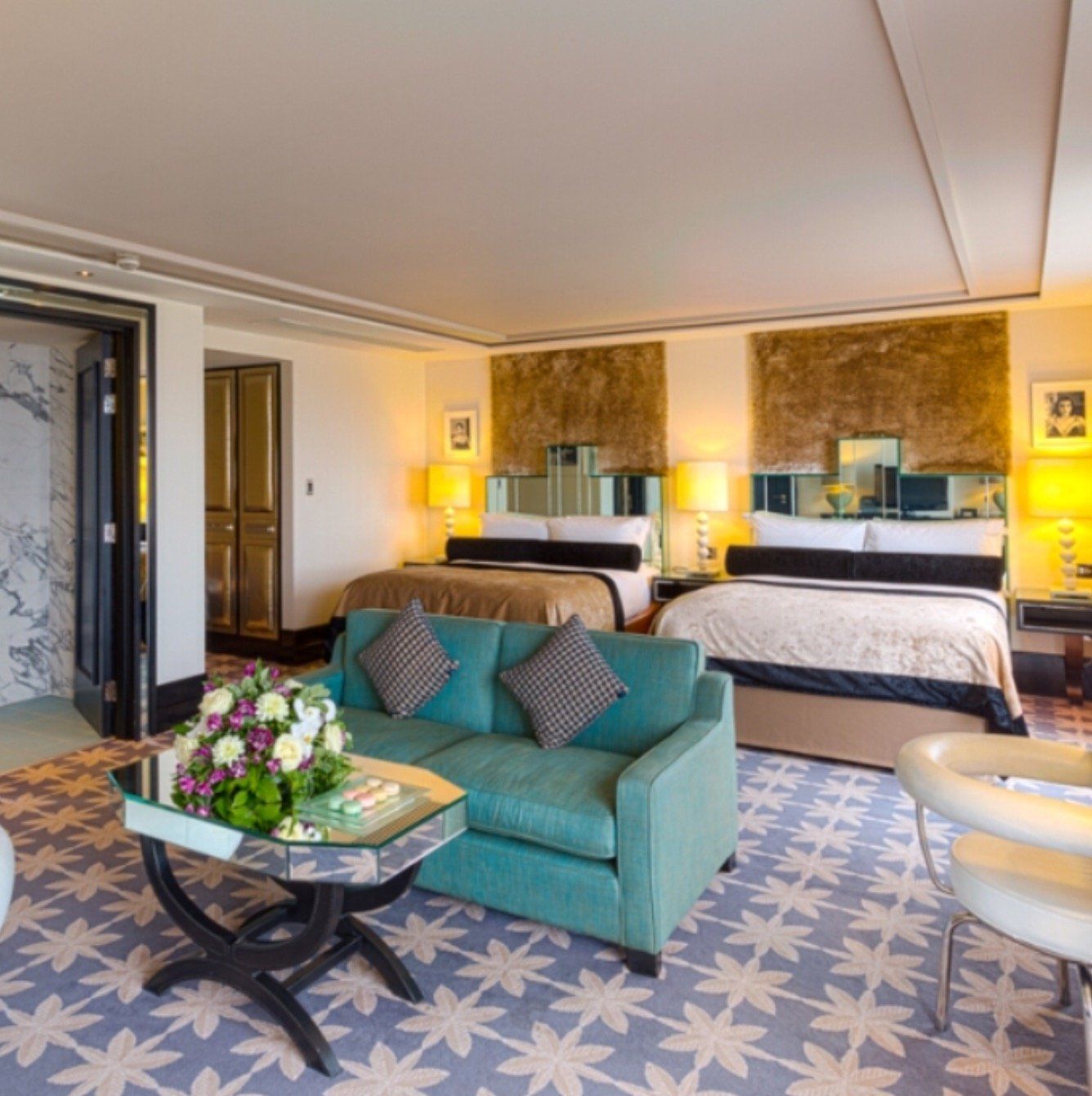 A hotel room with two beds and a couch