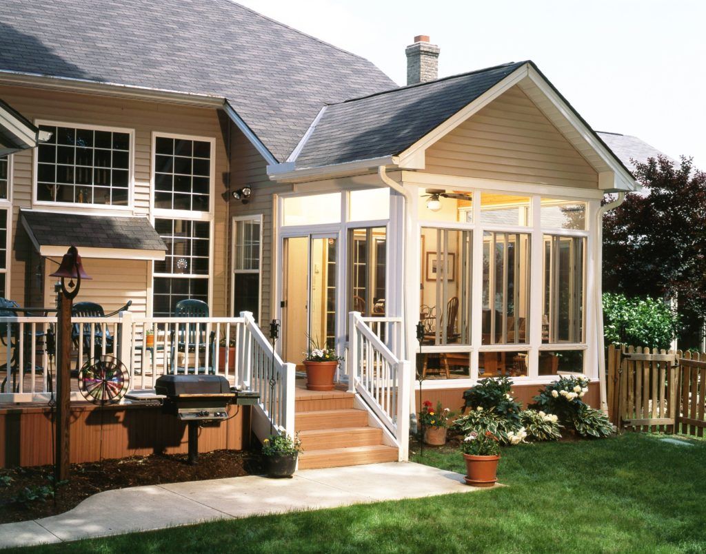 A house with a screened in porch and stairs
