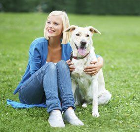 Pet — Pet and His Owner Sitting on the Grass in Citrus Heights, CA