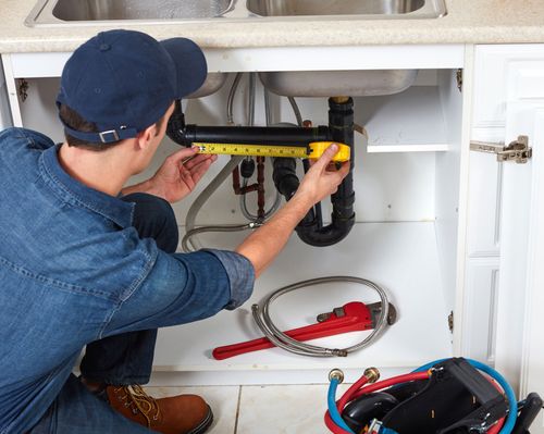 Dismukes Plumbing — Measuring Pipe Under the Sink in Spanish Fort, AL Dismukes Plumbing — Measuring Pipe Under the Sink in Spanish Fort, AL