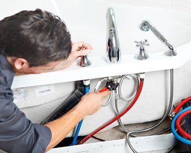 Plumber Fixing Pipe In Bathtub