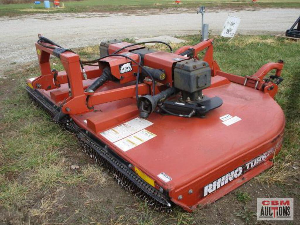 A red rhino turbo mower is sitting in the grass