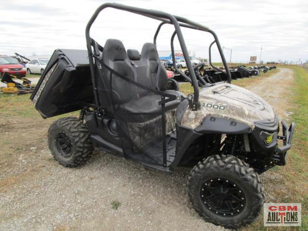 A utility vehicle is parked on the side of a gravel road.