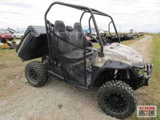A utility vehicle is parked on the side of a gravel road.