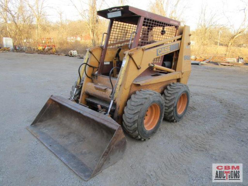 A case skid steer is parked in a dirt lot