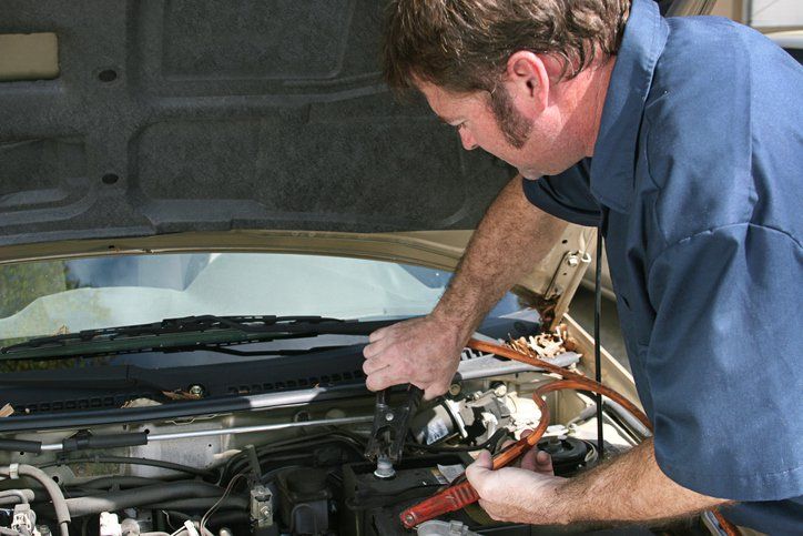 Plugs — Mechanic Using Jumper Cables in Lafayette, IN Plugs — Mechanic Using Jumper Cables in Lafayette, IN