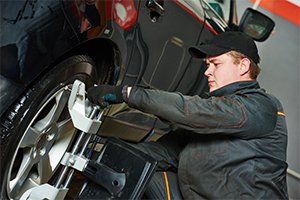Struts — Mechanic Installing Sensor During Suspension Adjustment in Lafayette, IN Struts — Mechanic Installing Sensor During Suspension Adjustment in Lafayette, IN