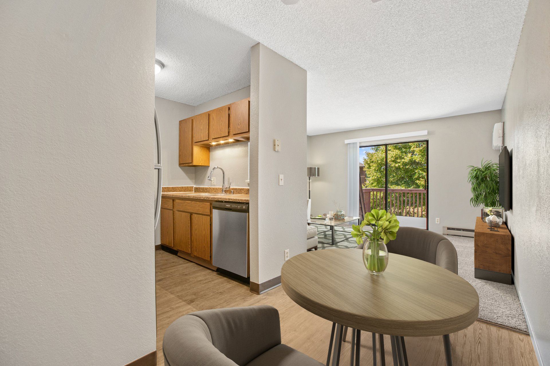 View of dining room area and kitchen entryway, with the sliding door leading to the balcony