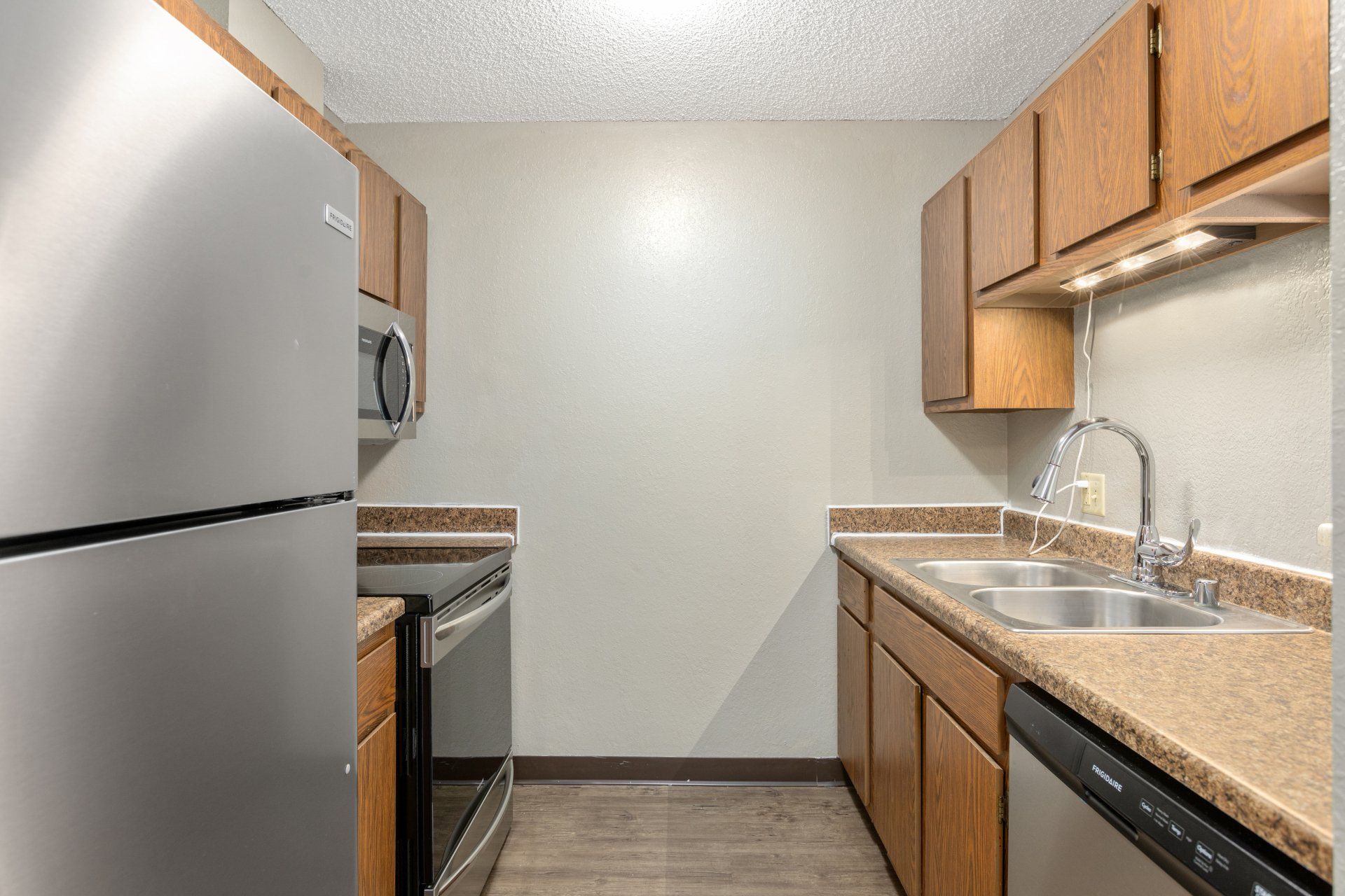 Alternate view of kitchen with full appliances and cabinetry