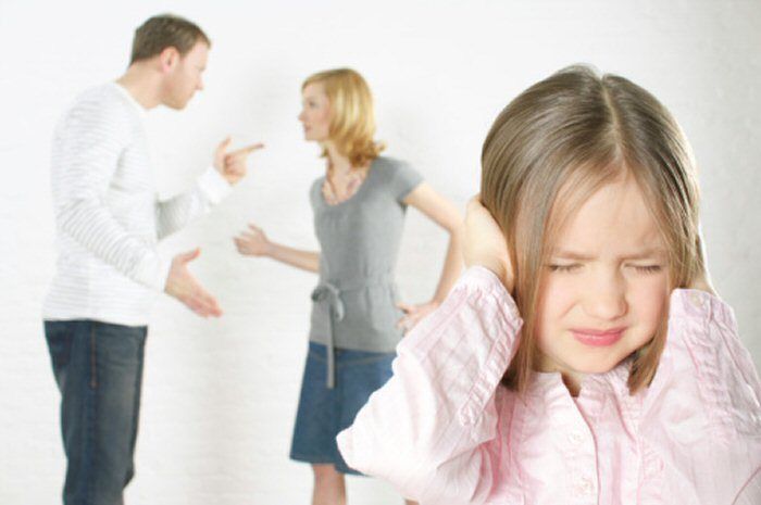 Child covers ears, distressed, as parents argue in the background, pointing and gesturing angrily.
