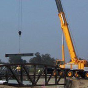Crane Holding Huge Metal Part — Hesperia, CA — KAT Cranes Crane Holding Huge Metal Part — Hesperia, CA — KAT Cranes