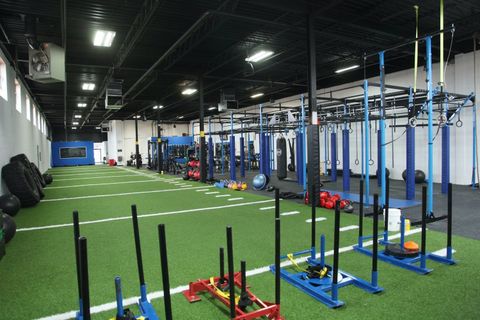 A large gym filled with lots of exercise equipment.