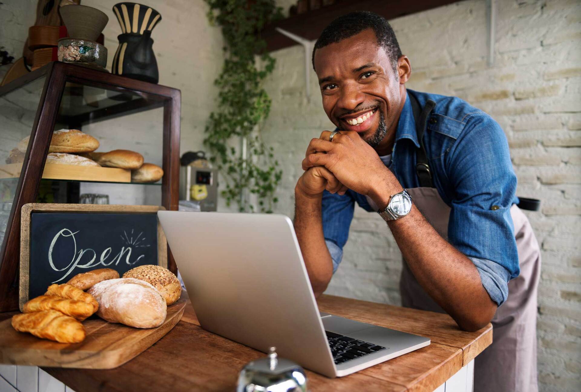 Bakery Shop Owner Using Laptop — St. Petersburg, FL — Genesis 41 Advisory Services LLC