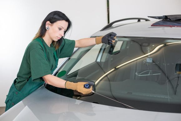 a lady removing the windshield